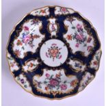 AN 18TH CENTURY WORCESTER SILVER SHAPED PLATE painted with English flowers upon a blue ground. 19 c