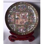 A HUGE 20TH CENTURY CHINESE FAMILLE ROSE CANTON ENAMEL PORCELAIN CHARGER, decorated with panels of