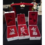 THREE BOXED SWAROVSKI MASQUERADE FIGURINES, together with associated stage.