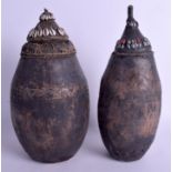 TWO AFRICAN TRIBAL NAMIBIAN OVOID CARRIERS AND COVERS with conch shell mounts. 31 cm high. (2)