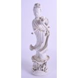 AN EARLY 20TH CENTURY CHINESE BLANC DE CHINE FIGURE OF GUANYIN modelled holding a flower. 30 cm hig