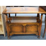 AN EARLY 20TH CENTURY OAK SETTLE, formed with a sliding top and carved foliate type decoration. 94