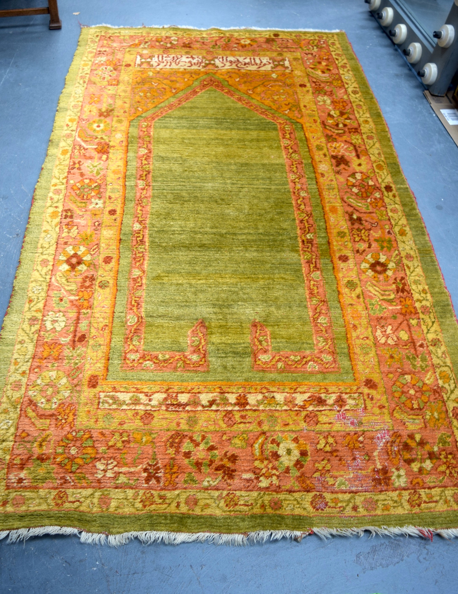 AN EARLY 20TH CENTURY ISLAMIC ORANGE GROUD PRAYER MAT RUG, bearing possible signature. 215 cm x 121