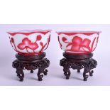 A PAIR OF EARLY 20TH CENTURY CHINESE PEKING GLASS BOWLS Qing, upon fitted stands. 11.5 cm wide. (4)