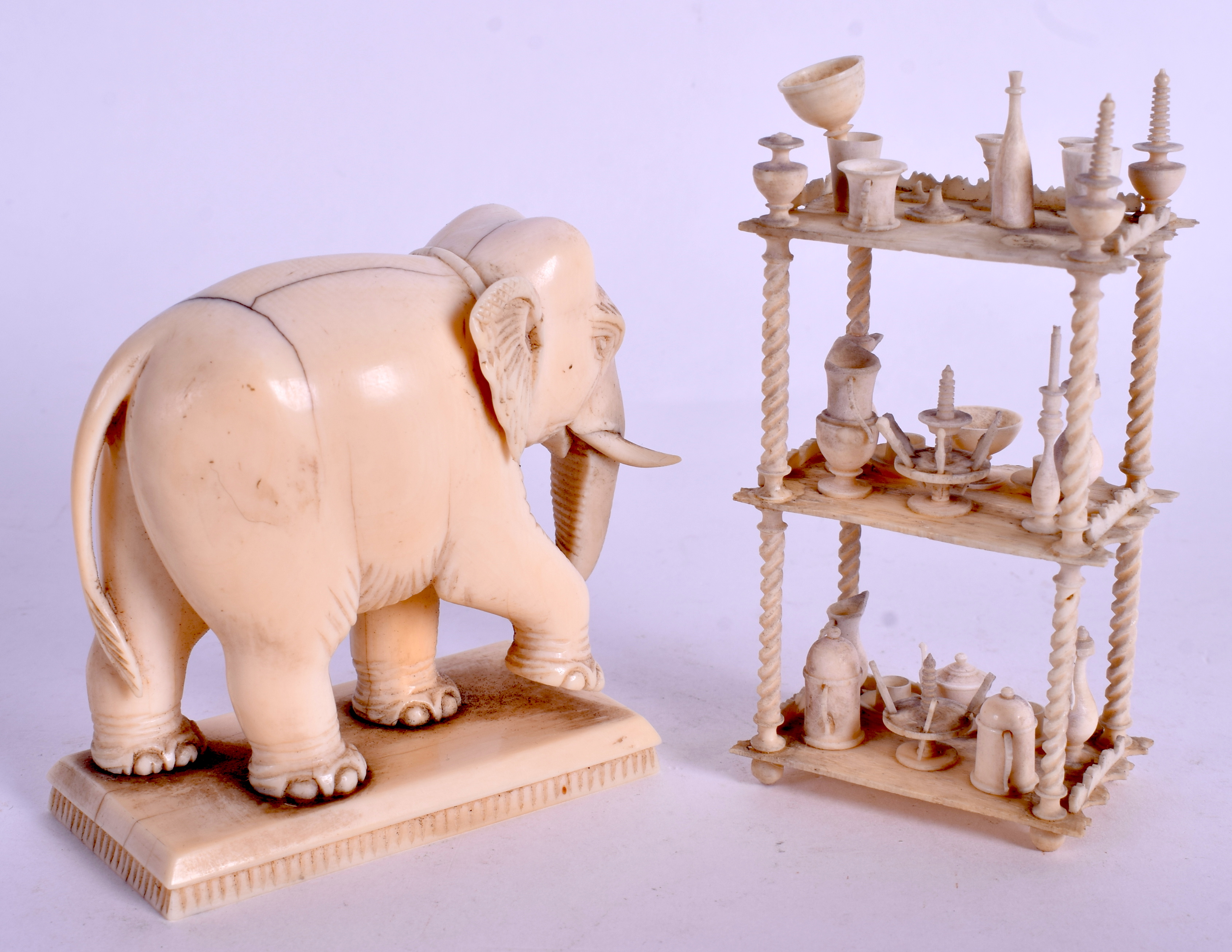 A 19TH CENTURY INDIAN CARVED IVORY ELEPHANT together with a carved bone prisoner of war dumb waiter - Image 2 of 2