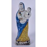 A 19TH CENTURY FRENCH FAIENCE POTTERY FIGURE OF MADONNA modelled with child. 28 cm high.