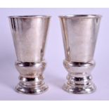 A PAIR OF EARLY 20TH CENTURY CHINESE HAMMERED SILVER BEAKERS. 328 grams. 15 cm high.