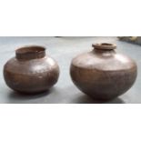 A NEAR PAIR OF GLOBULAR METAL POTS, formed with stud work banding. Largest 37 cm wide. (2)