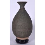 A CHINESE GREEN GLAZED POTTERY VASE, formed with a bulbous body and incised with foliage, together