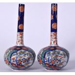 A PAIR OF EARLY 20TH CENTURY JAPANESE IMARI PORCELAIN VASE, painted with panels of foliage. 22.5 cm