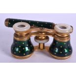 A PAIR EDWARDIAN BRASS AND GREEN ENAMEL OPERA GLASSES. 18 cm extended.
