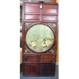 A CHINESE WOODEN DOOR PANEL, painted with an exotic bird in a circular panel. 144 cm x 65 cm.