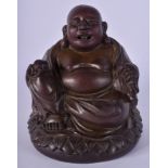 A 17TH/18TH CENTURY CHINESE BRONZE BUDDHA modelled upon a lotus base. 19 cm x 11 cm.