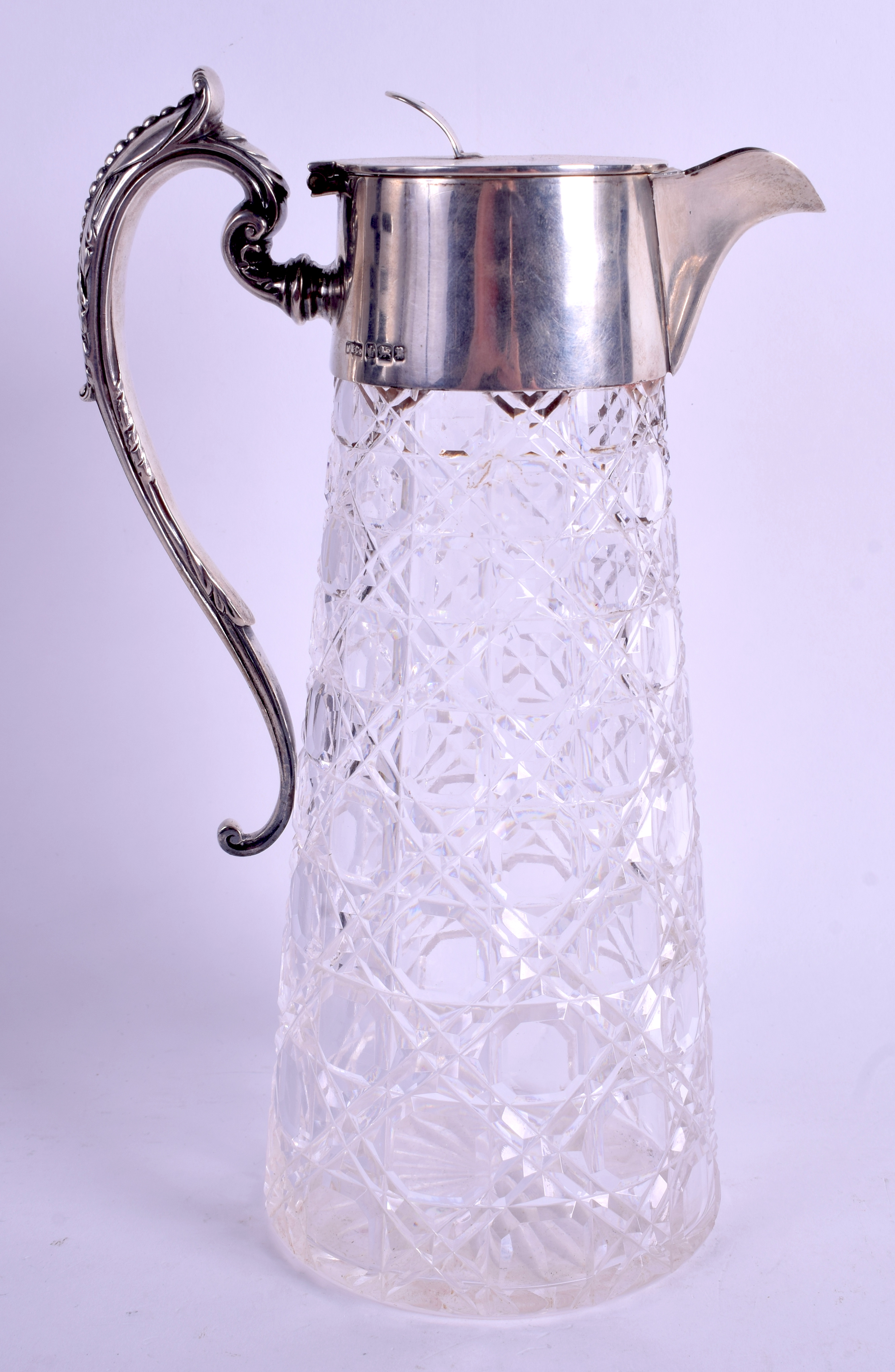 AN EDWARDIAN SILVER AND CUT GLASS CLARET JUG. Sheffield 1907. 26 cm high.