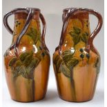 A LARGE PAIR OF BELGIAN AESTHETIC MOVEMENT PORCELAIN VASE, three handled and decorated in relief wi