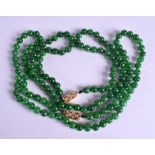 A PAIR OF 18CT GOLD DIAMOND CHINESE JADEITE NECKLACES. 60 cm long.