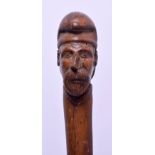 A 19TH CENTURY BAVARIAN BLACK FOREST CARVED WOOD WALKING STICK with portrait terminal. 85 cm long.