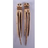 A PAIR OF UNUSUAL 19TH CENTURY TRIBAL IVORY HAIR SLIDES. 12 cm long.