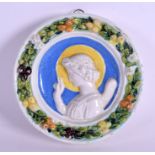 A 19TH CENTURY CONTINENTAL DELLA ROBIA POTTERY MAJOLICA PLAQUE painted with a saint amongst fruitin