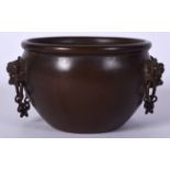 A 20TH CENTURY CHINESE BRONZE CENSER, formed with twin mask head handles, signed. 12 cm wide.