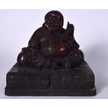 A FIGURE OF A CHINESE BRONZE BUDDHA, formed with his bulging sack in one hand and the other raised.