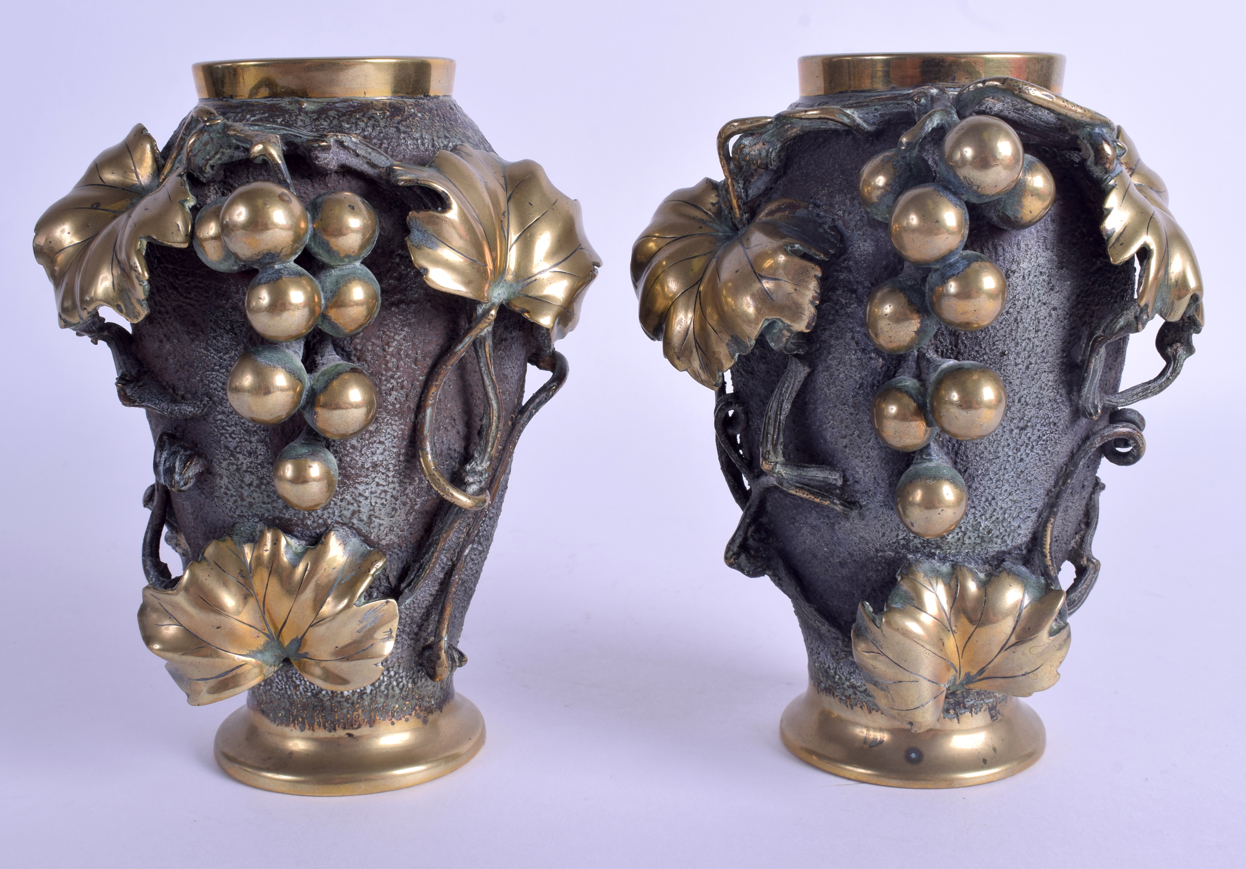 A PAIR OF 19TH CENTURY JAPANESE MEIJI PERIOD BRONZE VASES overlaid with berries and vines. 16 cm hi