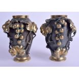 A PAIR OF 19TH CENTURY JAPANESE MEIJI PERIOD BRONZE VASES overlaid with berries and vines. 16 cm hi