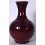 A LARGE CHINESE FLAMBE GLAZED PORCELAIN VASE, bulbous in shape with a flared rim. 34.5 cm high.