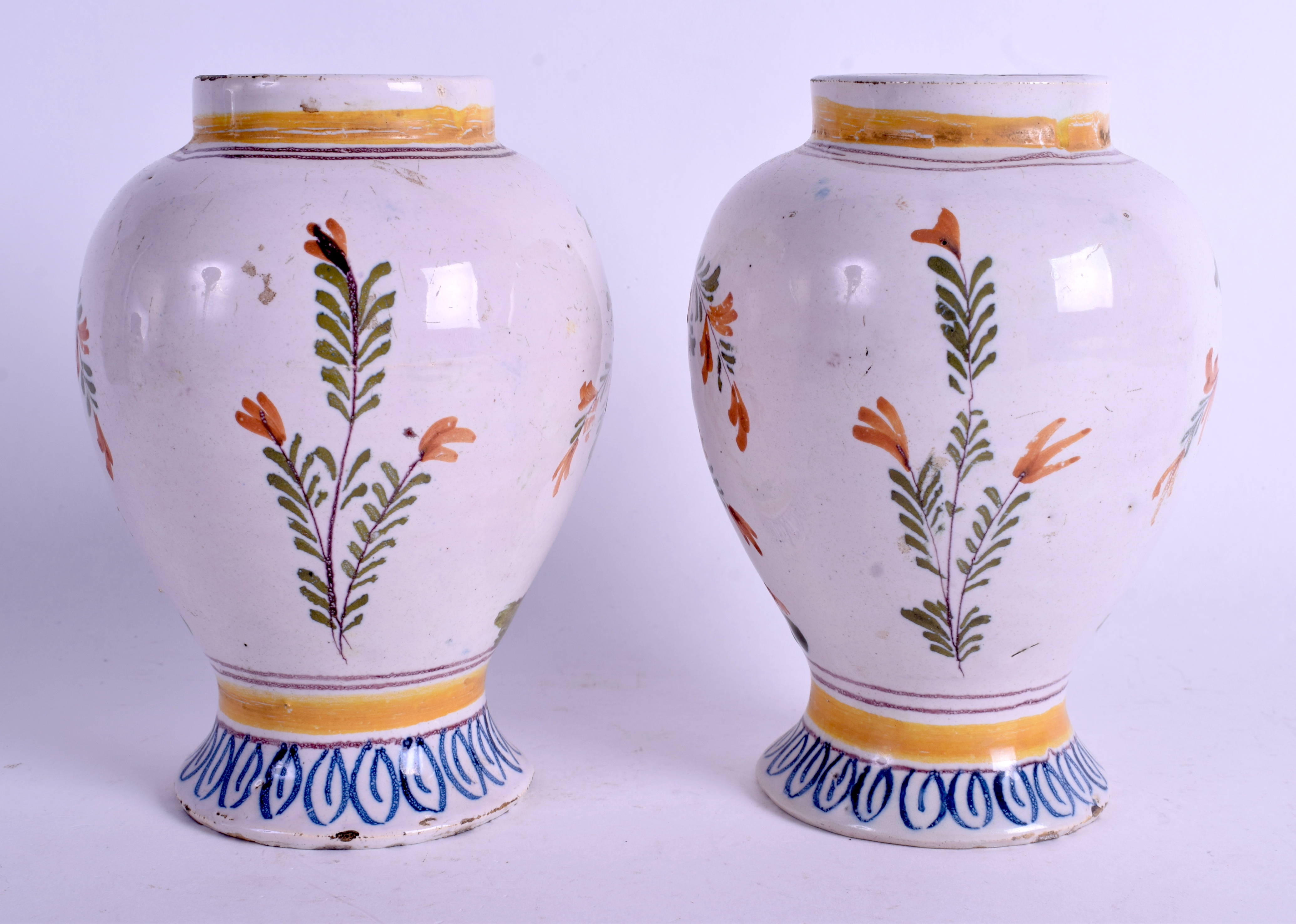 A PAIR OF 18TH CENTURY DUTCH DELFT POLYCHROME VASES painted with floral sprays. 16 cm high. - Image 2 of 3