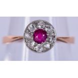 AN 18CT GOLD DIAMOND AND RUBY RING. 1.7 grams. Size L.