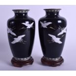 A PAIR OF EARLY 20TH CENTURY JAPANESE TAISHO PERIOD CLOISONNE ENAMEL VASES decorated with birds. 15