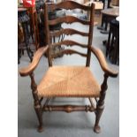 AN ANTIQUE OAK CARVER CHAIR, with thatched seat and pad feet. 108 cm x 68.5 cm.