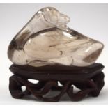 A CHINESE QING DYNASTY ROCK CRYSTAL CARVED BIRD SCULPTURE, modeled upon a fitted hardwood stand. 6.