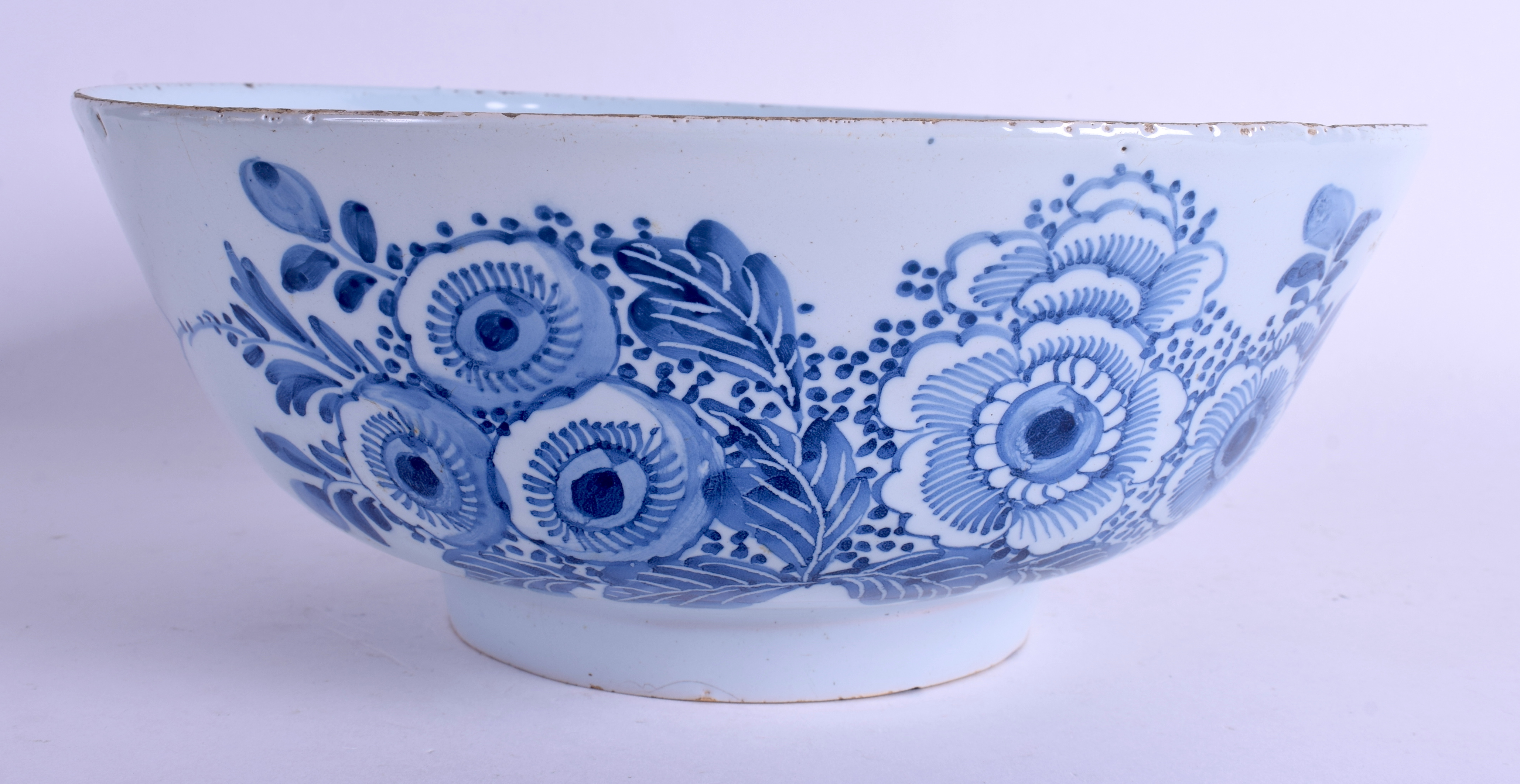 A MID 18TH CENTURY ENGLISH LONDON DELFT CIRCULAR BOWL C1750 painted with flowers and vines. 26.5 cm