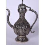 A LARGE PERSIAN WHITE METAL EWER, decorated with panels of foliage. 37 cm high.