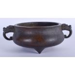 A CHINESE TWIN HANDLED BRONZE CENSER. 15 cm wide.