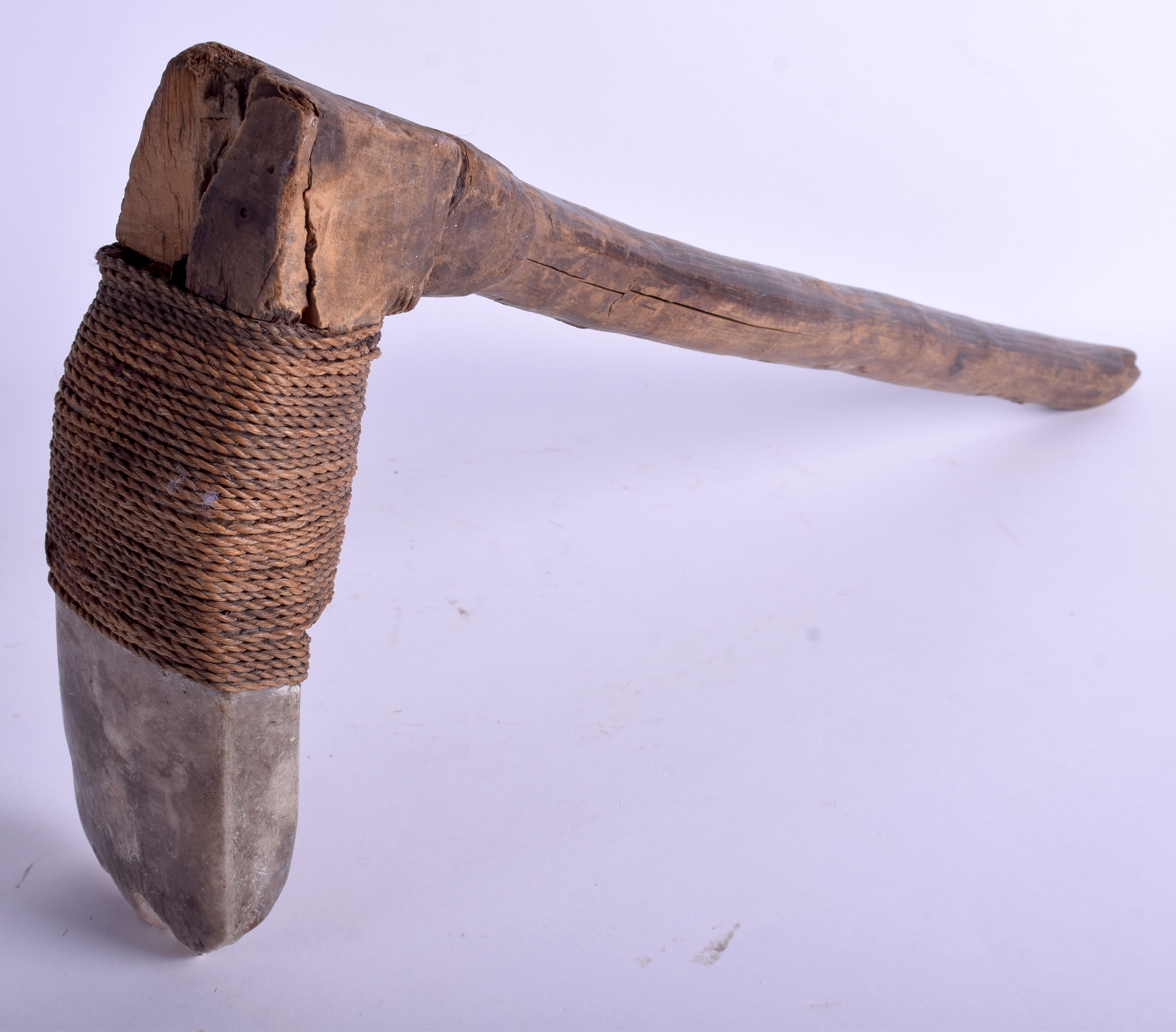 AN UNUSUAL 19TH CENTURY CARVED STONE TRIBAL ROPE BOUND AXE. 56 cm x 25 cm.