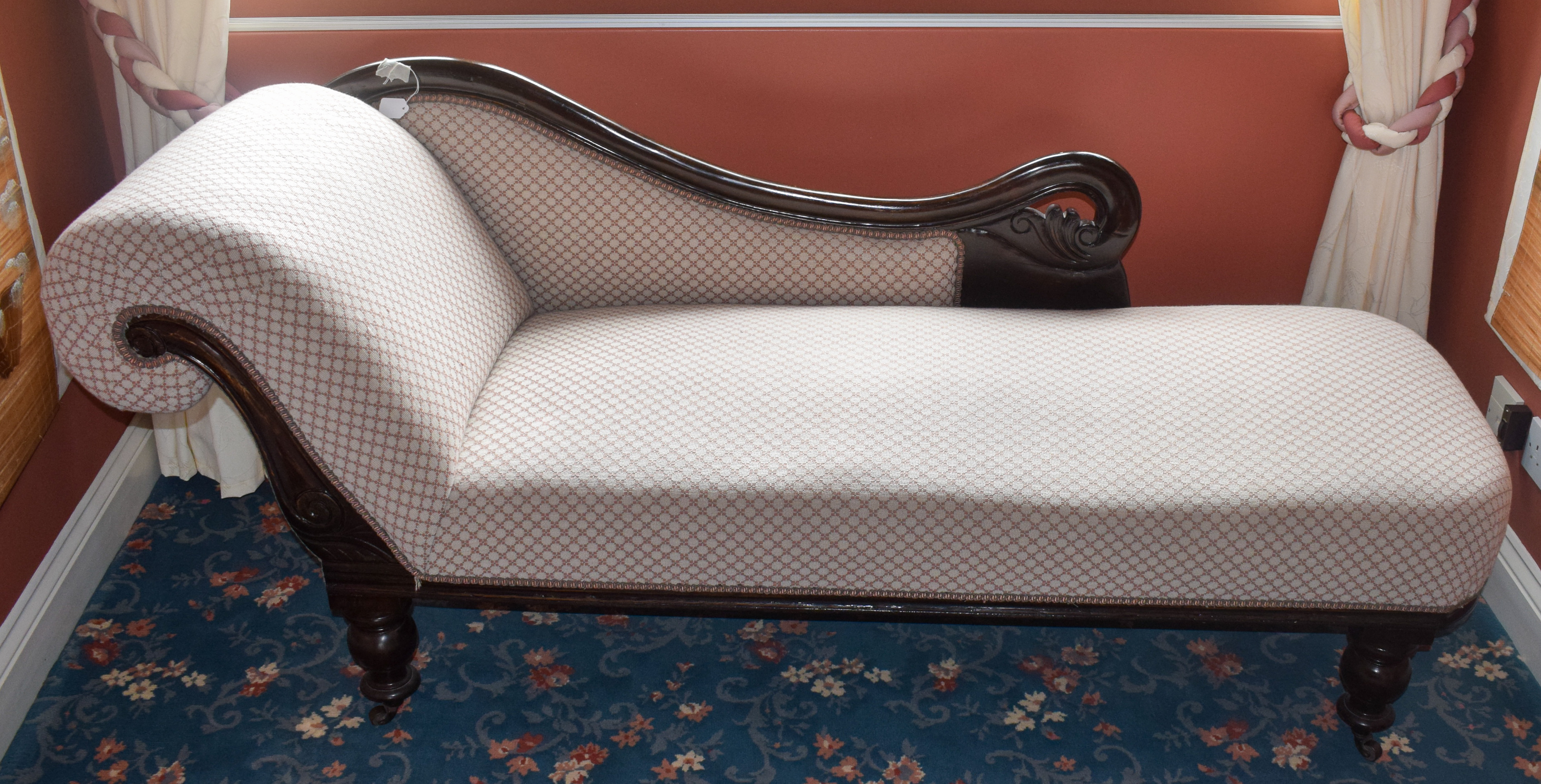 AN ANTIQUE CHAISE LOUNGE, honeycomb type upholstery. 80 cm x 190 cm.