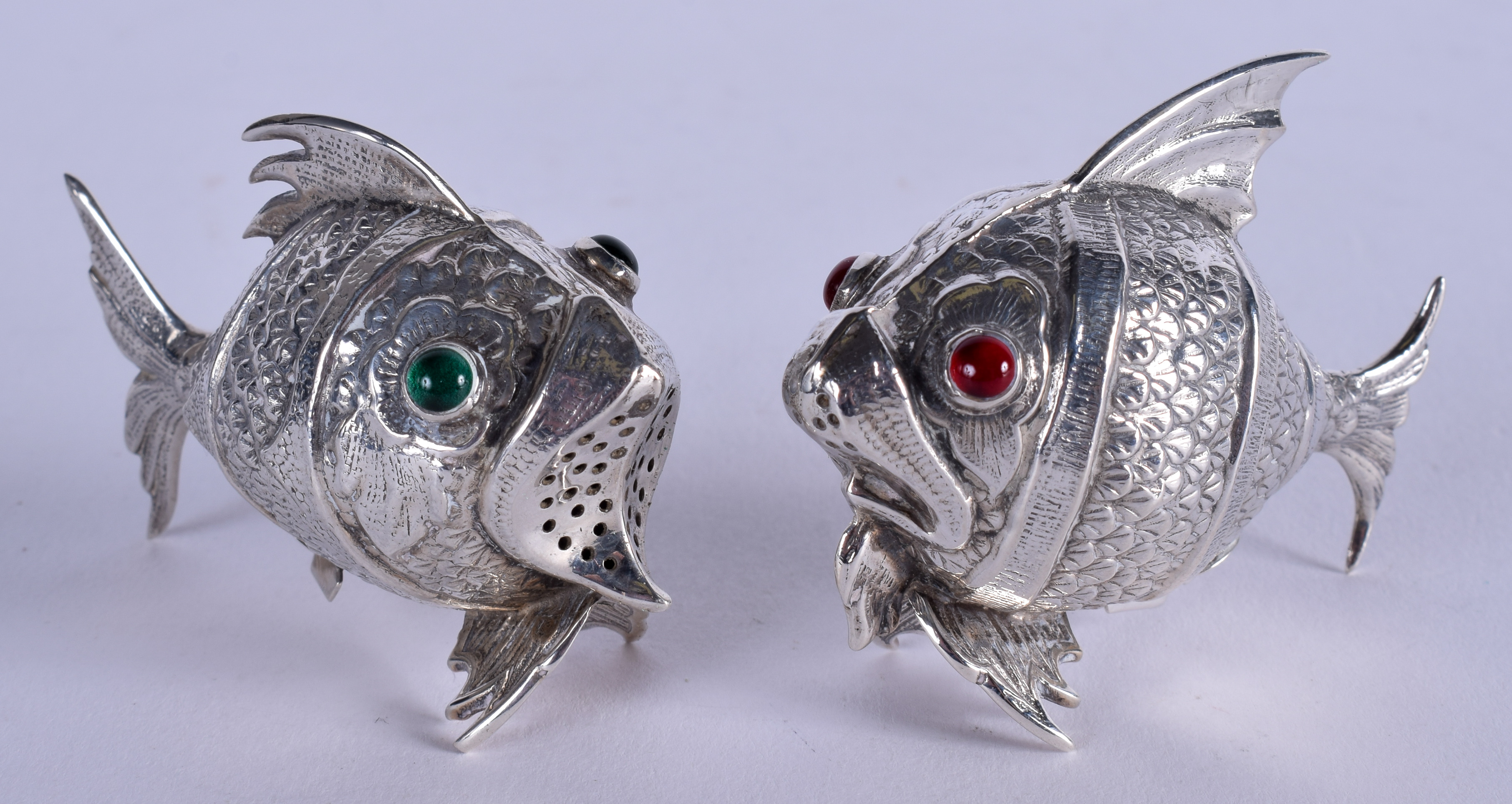 A PAIR OF 1950S SPANISH GEM SET SILVER CONDIMENTS in the form of fish. 5.75 cm wide.