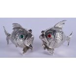 A PAIR OF 1950S SPANISH GEM SET SILVER CONDIMENTS in the form of fish. 5.75 cm wide.