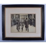 AN EARLY 20TH CENTURY PHOTOGRAPH OF MILITARY INTEREST, depicting a male outside Buckingham Palace a