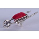 A SILVER WHEELBARROW PIN CUSHION. 5 cm wide.