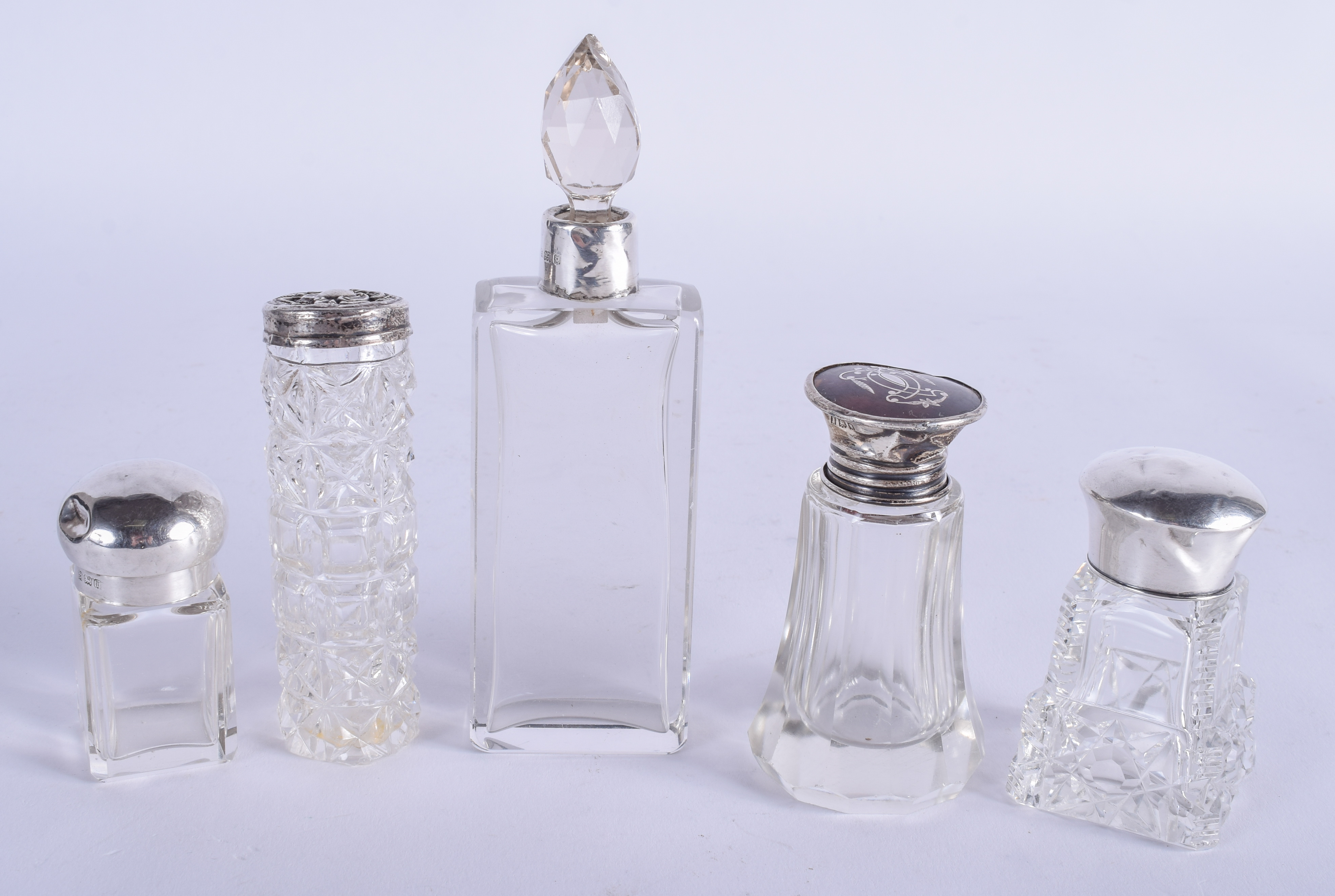 FIVE VINTAGE SILVER TOPPED GLASS DRESSING TABLE JARS. Largest 11 cm high. (5)