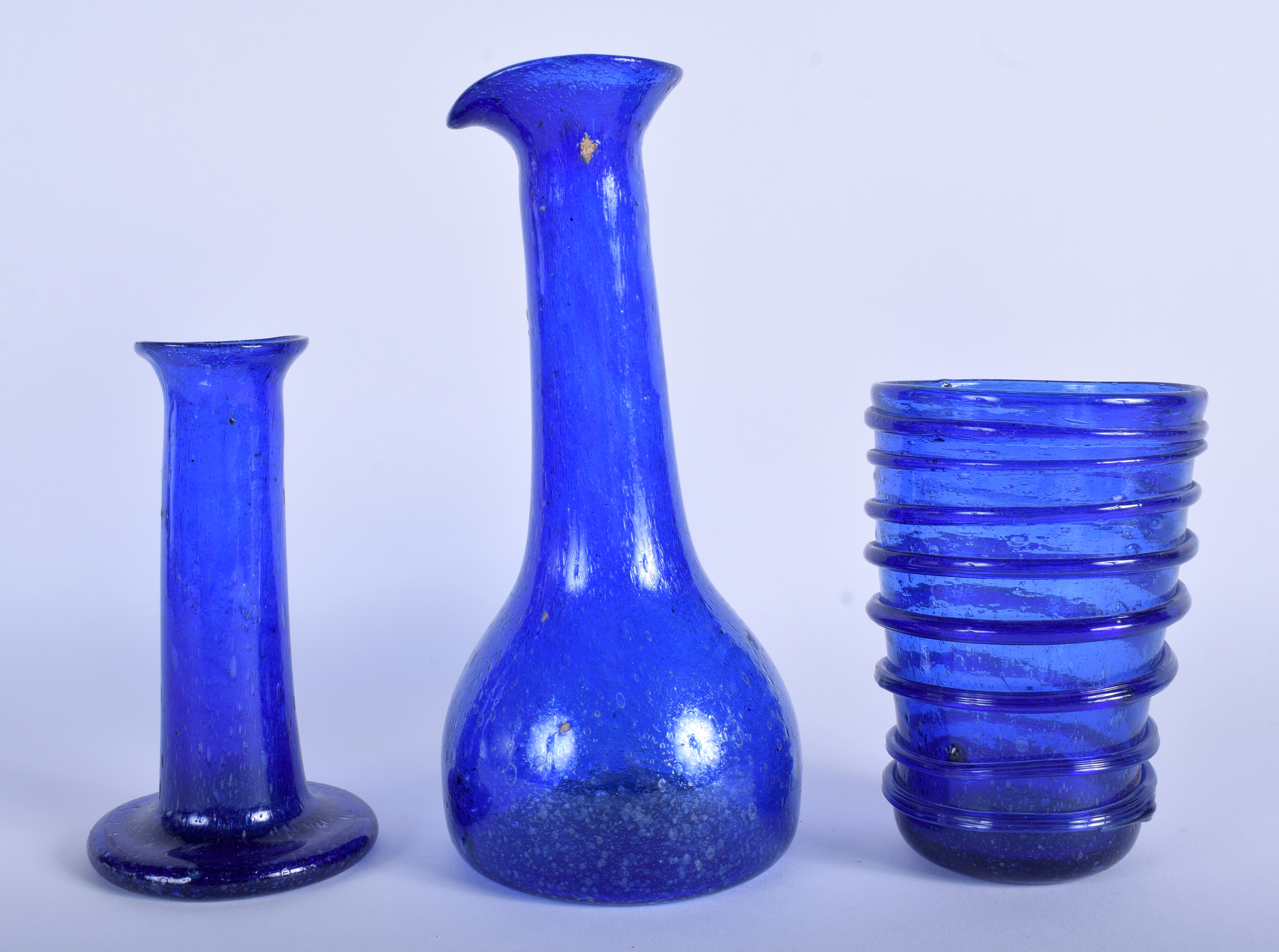 THREE CENTRAL ASIAN BLUE GLASSES. Largest 20 cm high. (3)