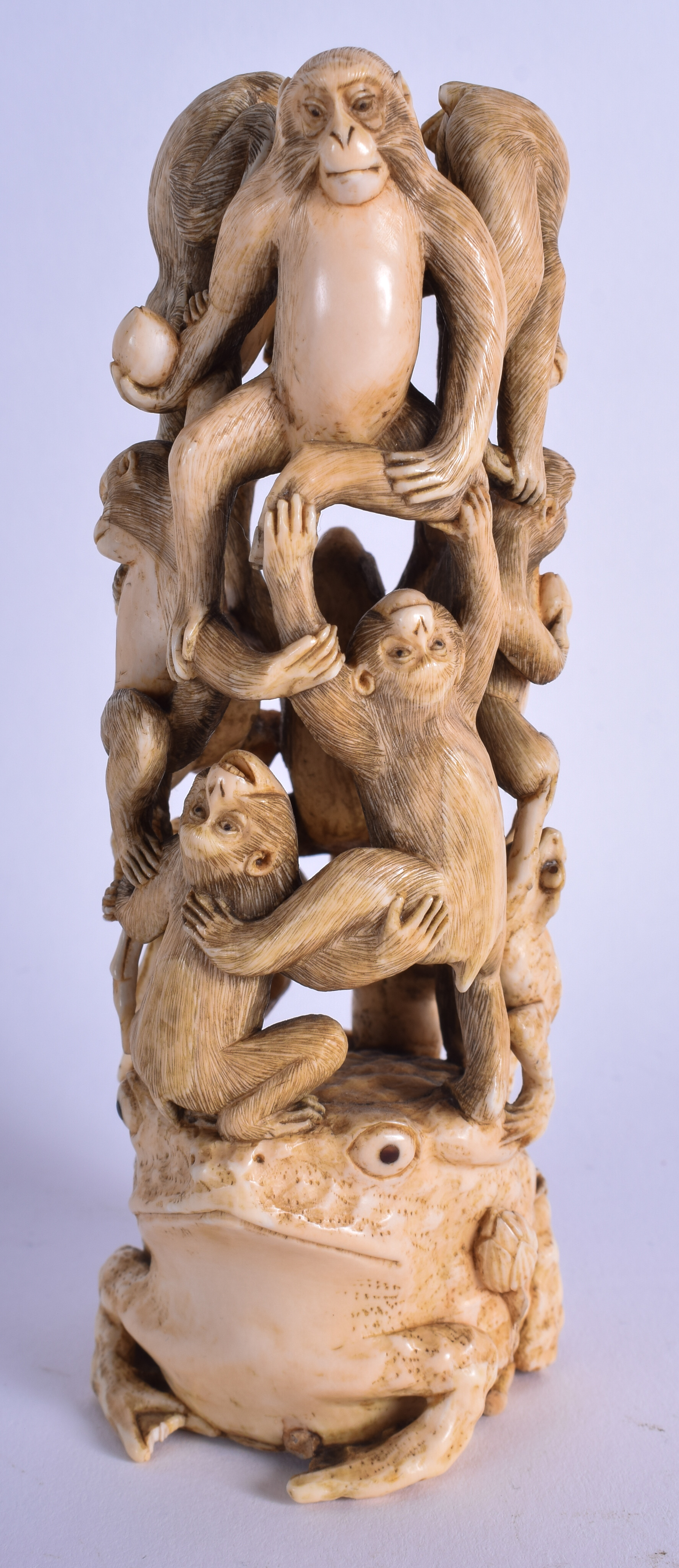 A 19TH CENTURY JAPANESE MEIJI PERIOD CARVED IVORY OKIMONO modelled with numerous monkeys clambering