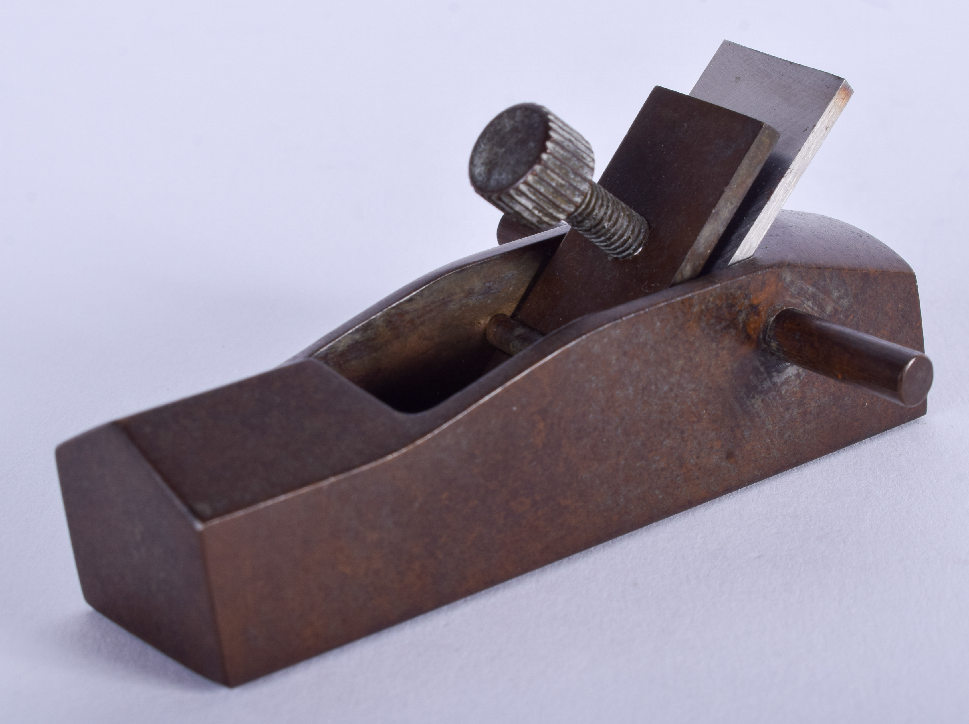 A JAPANESE BRONZE OKIMONO modelled as a carpenters plane. 8.5 cm wide.