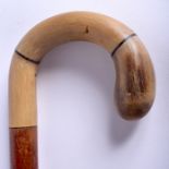 A 19TH CENTURY RHINOCEROS HORN HANDLED WALKING CANE. 88 cm long.