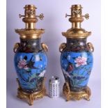 A FINE PAIR OF 19TH CENTURY FRANCO JAPANESE BRONZE AND CLOISONNE ENAMEL OIL LAMPS in the manner of