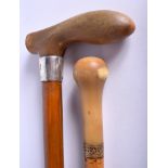 A 19TH CENTURY RHINOCEROS HORN HANDLED WALKING CANE together with another similar cane. 90 cm long.