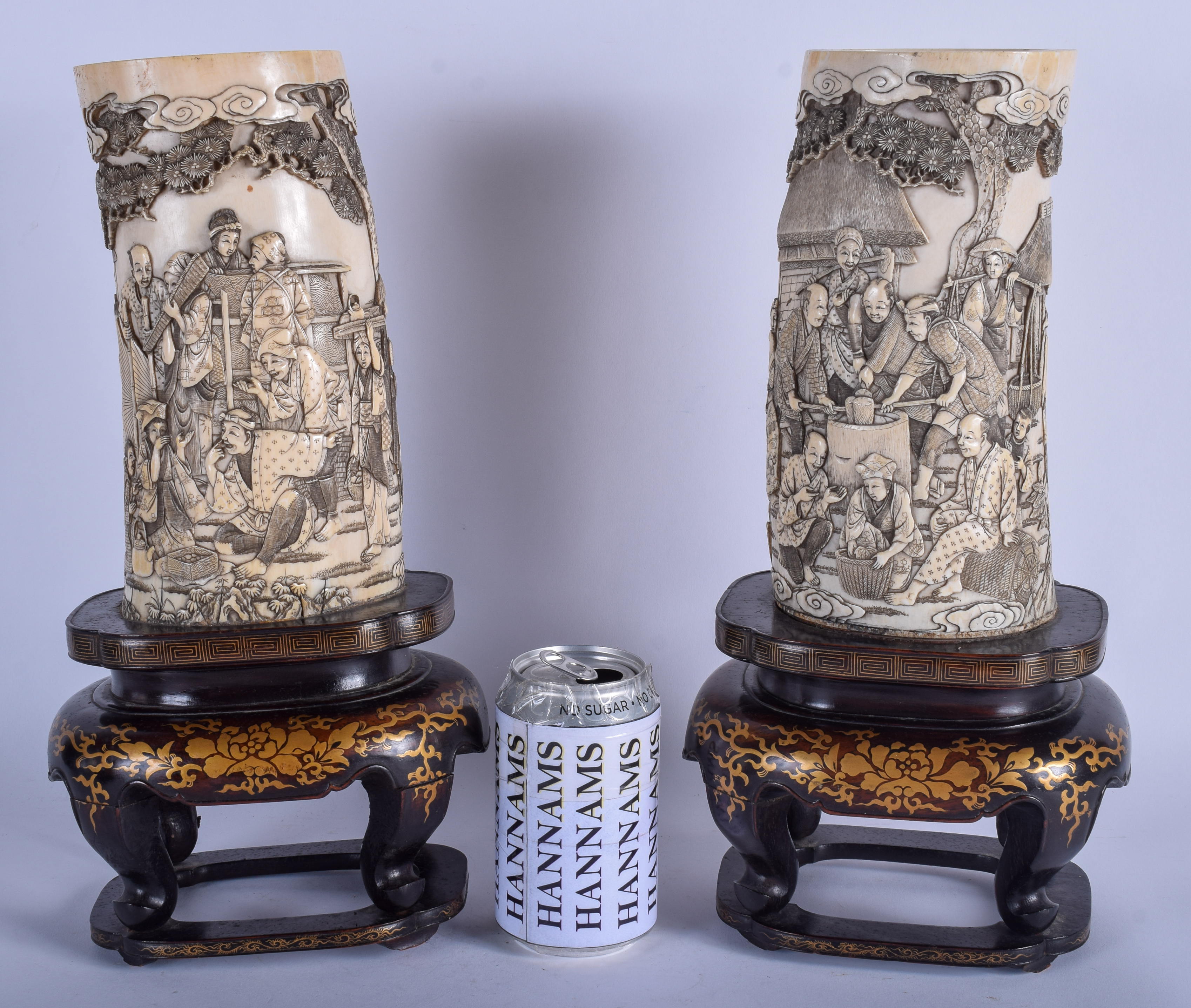 A LARGE PAIR OF 19TH CENTURY JAPANESE MEIJI PERIOD CARVED IVORY TUSK VASES upon lacquered bases. 37